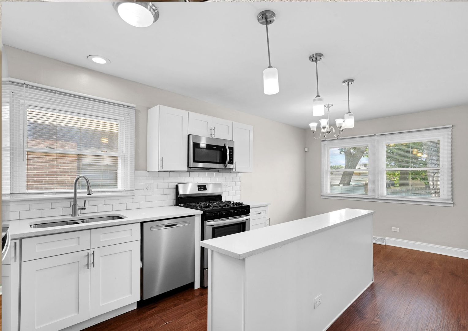 294 Madison Avenue Calumet City, IL 60409 - Photo 7 of 19 a kitchen with stainless steel appliances a sink stove and wooden floor