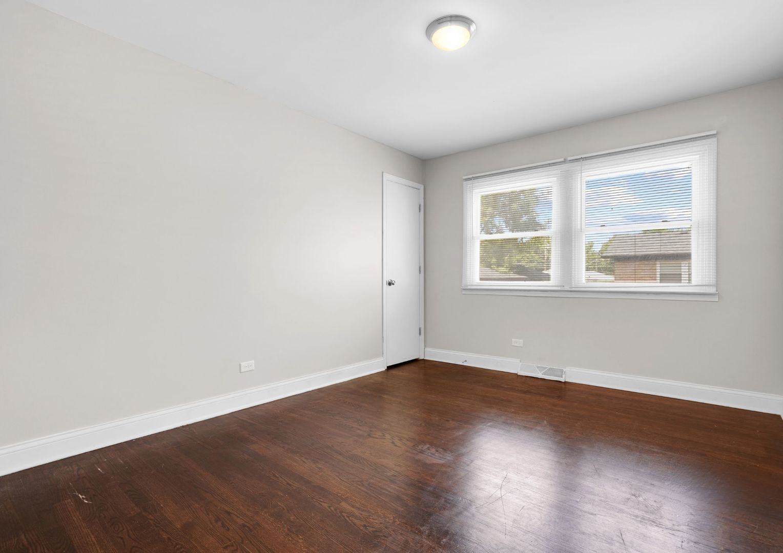 294 Madison Avenue Calumet City, IL 60409 - Photo 9 of 19 an empty room with wooden floor and windows