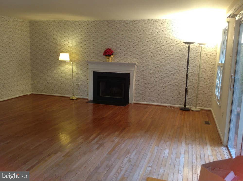 11624 Bootjack Court North Potomac, MD 20878 - Photo 4 of 15 a view of an empty room with wooden floor and a fireplace