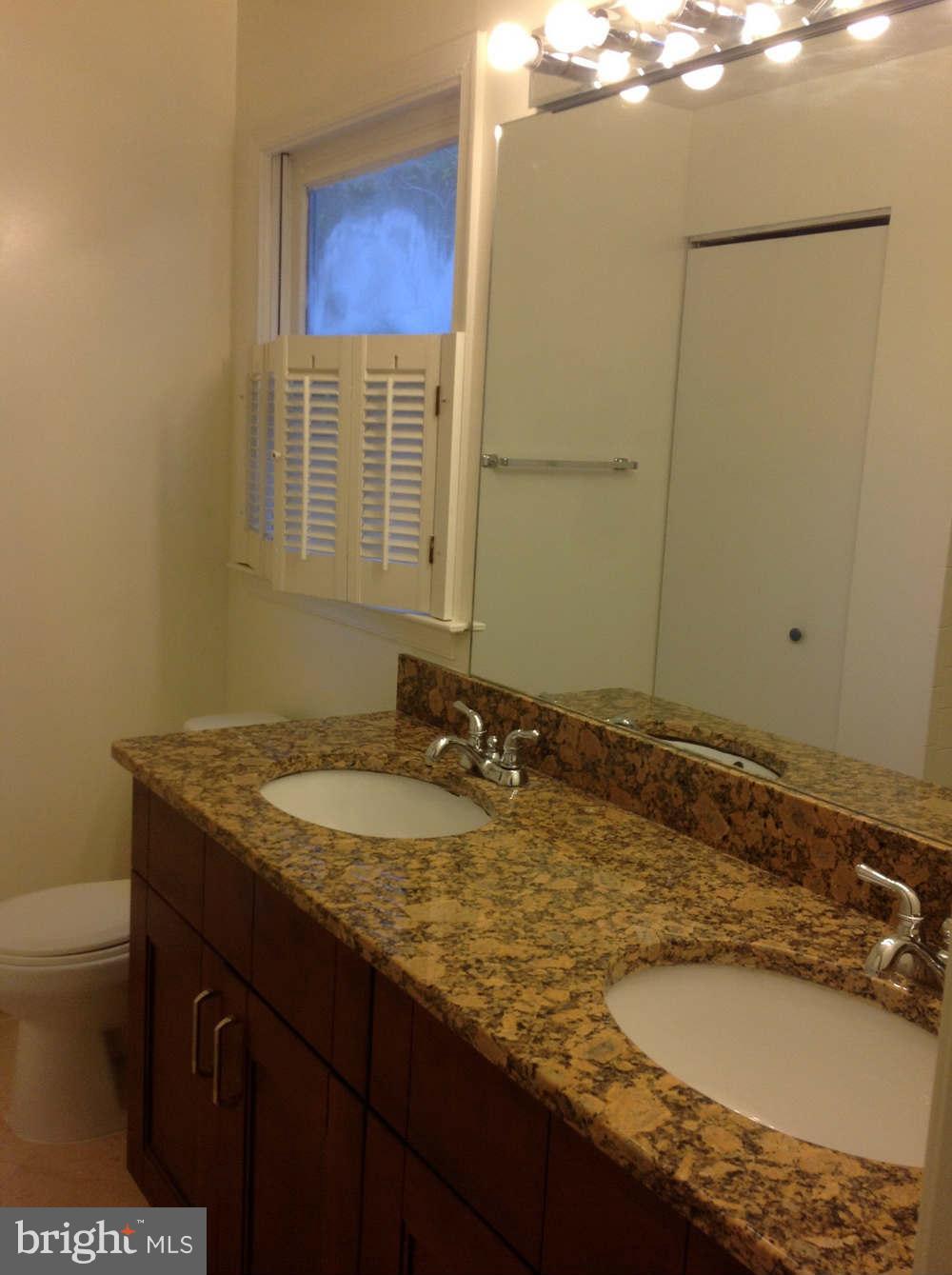11624 Bootjack Court North Potomac, MD 20878 - Photo 5 of 15 a bathroom with a granite countertop sink and a mirror