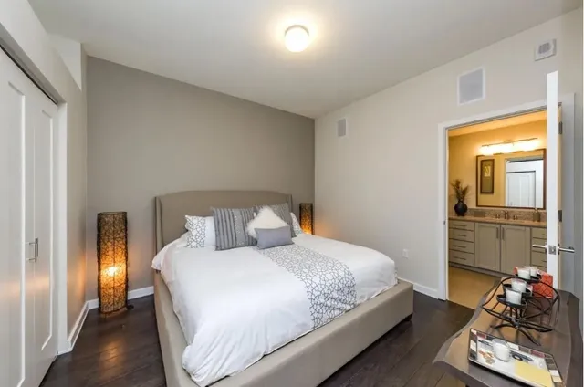 a bedroom with a bed and a table in it