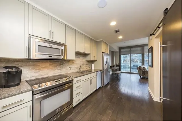 a kitchen with sink and white cabinets