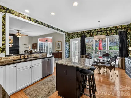 a large kitchen with lots of counter space and painting on the wall