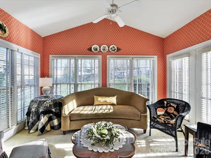 a living room with furniture and a floor to ceiling windows
