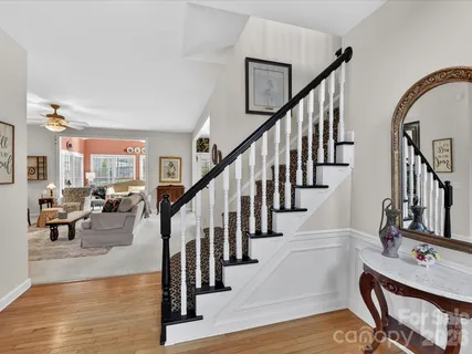 a view of entryway and hall with wooden floor