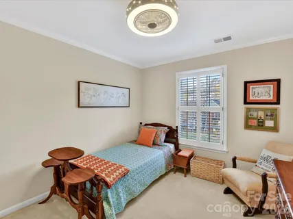 a bedroom with furniture and a window