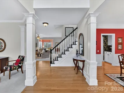 a view of entryway and hall with wooden floor