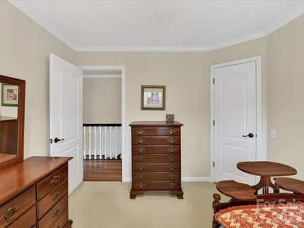 a bedroom with furniture and a chair