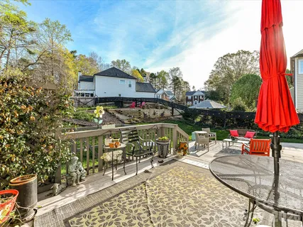 a view of house with a swimming pool and sitting area