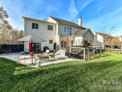 a view of a house with backyard and sitting area