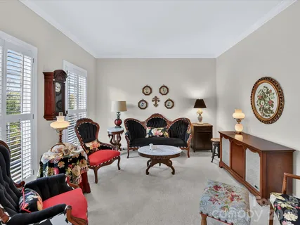 a living room with furniture and a clock