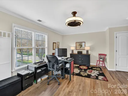 a workspace with furniture hardwood and a window