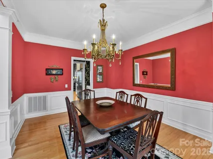 a view of a dining room with furniture and chandelier