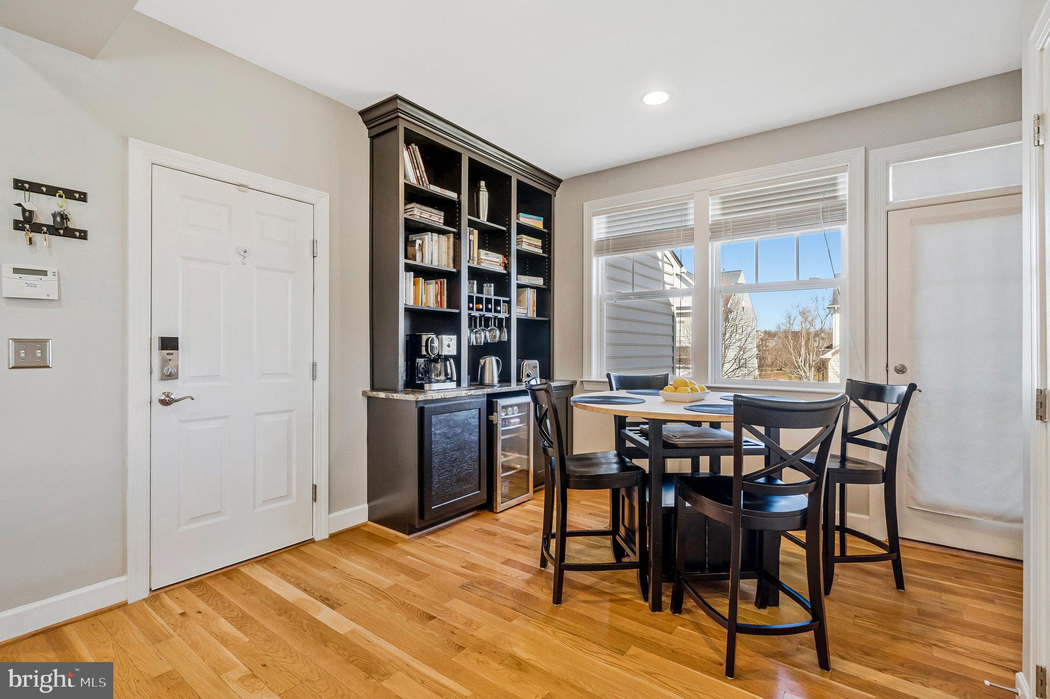 41008 Indigo Place Leesburg, VA 20175 - Photo 17 of 59 a view of a dining room with furniture and wooden floor