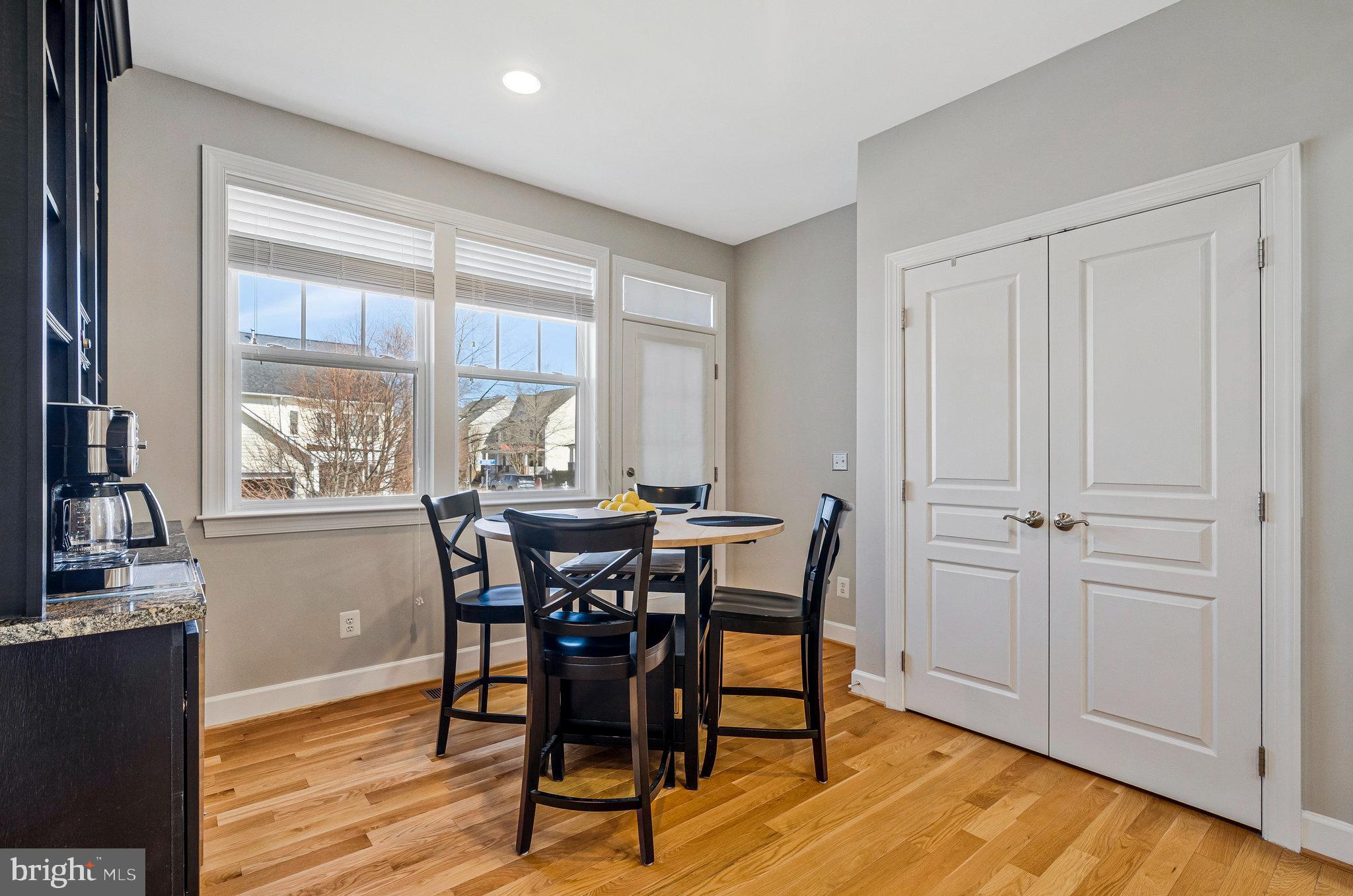 41008 Indigo Place Leesburg, VA 20175 - Photo 18 of 59 a view of a dining room with furniture window and wooden floor