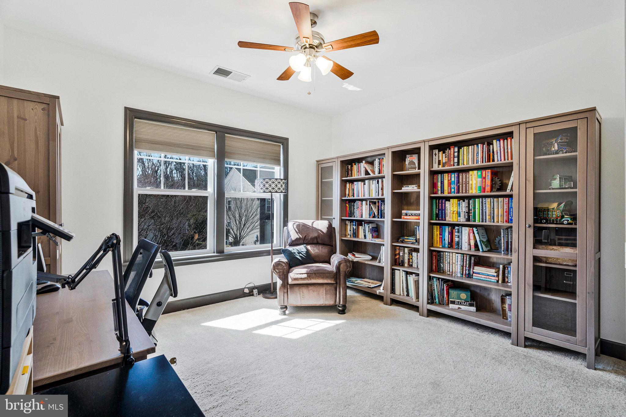 41008 Indigo Place Leesburg, VA 20175 - Photo 33 of 59 a living room with furniture and a book shelf