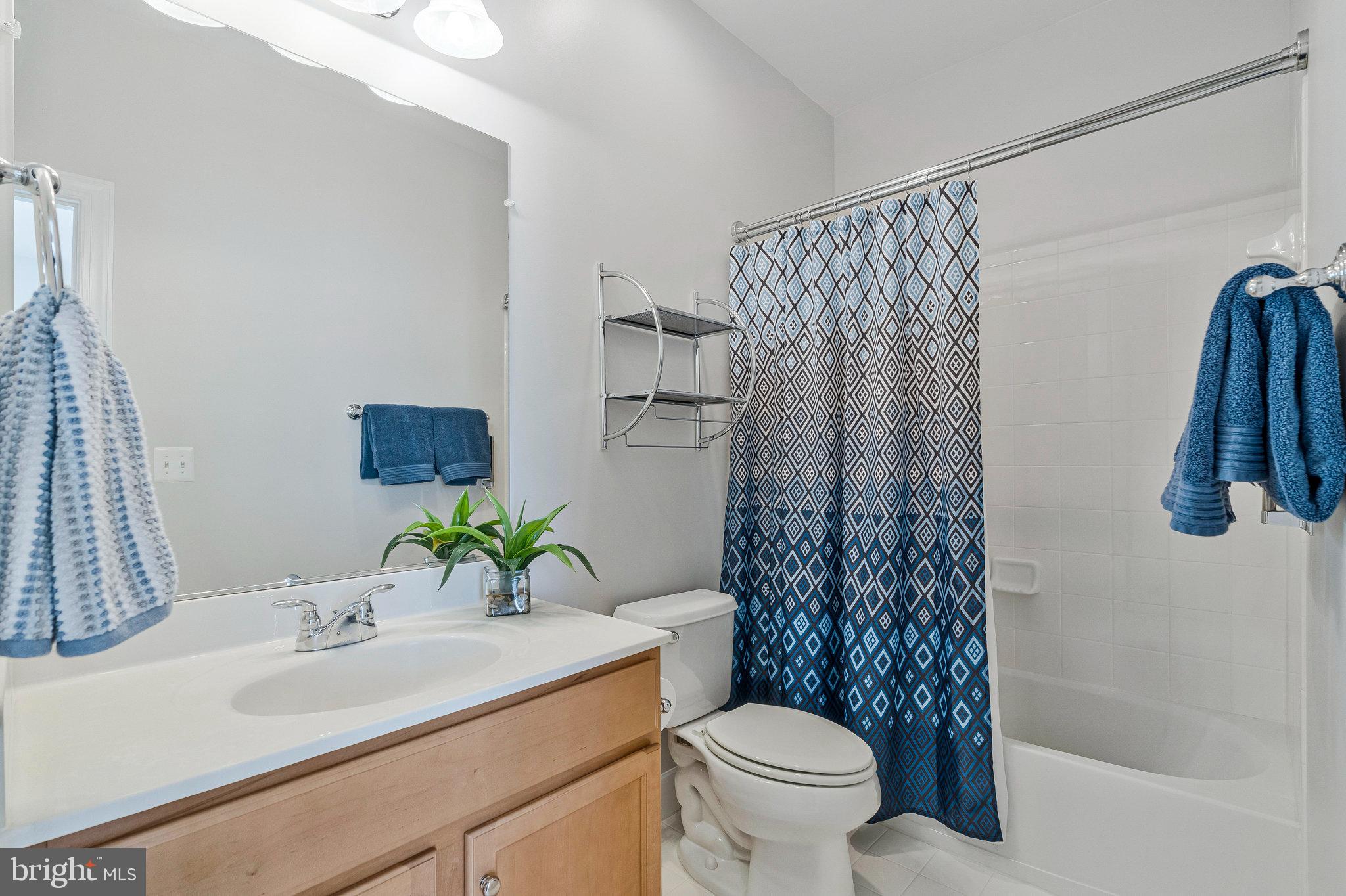 41008 Indigo Place Leesburg, VA 20175 - Photo 37 of 59 a bathroom with a sink toilet and shower