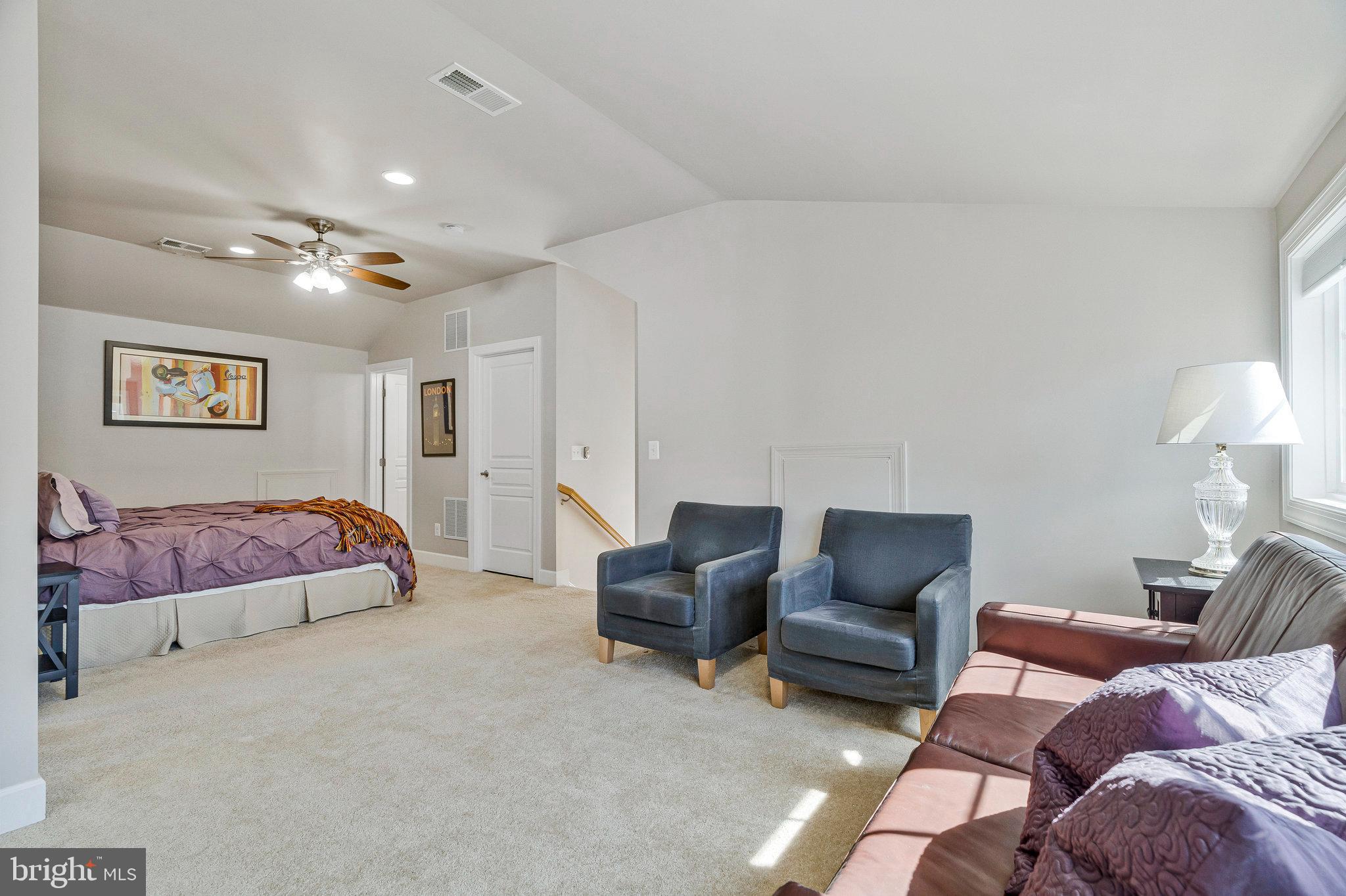 41008 Indigo Place Leesburg, VA 20175 - Photo 41 of 59 a bedroom with a bed and a lamp