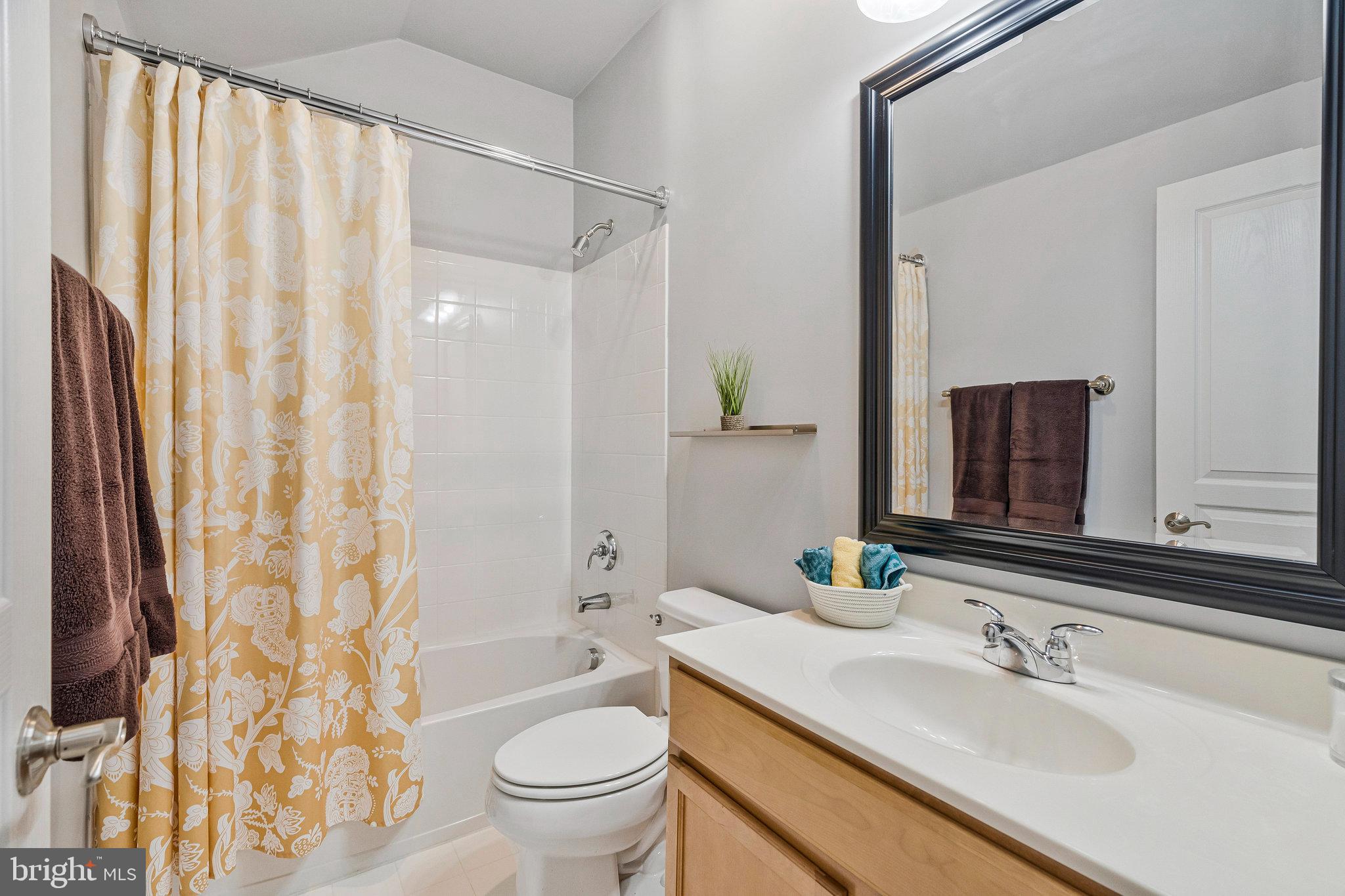 41008 Indigo Place Leesburg, VA 20175 - Photo 42 of 59 a bathroom with a sink toilet and shower