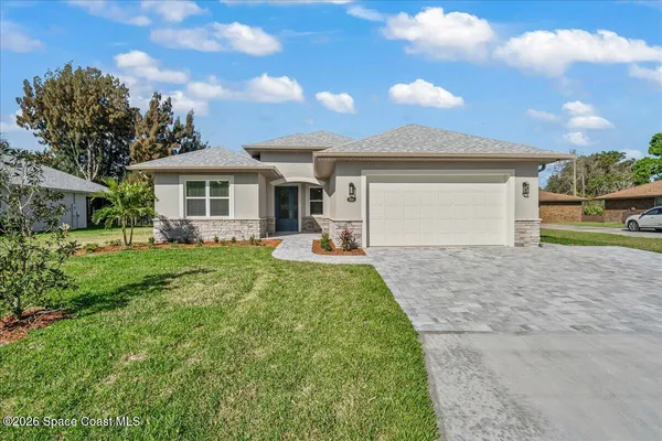 a front view of house with yard and green space