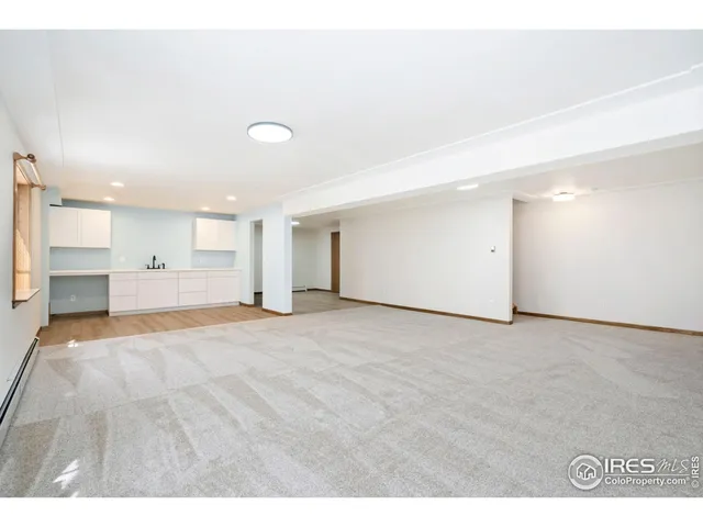 a kitchen with a sink cabinets and wooden floor