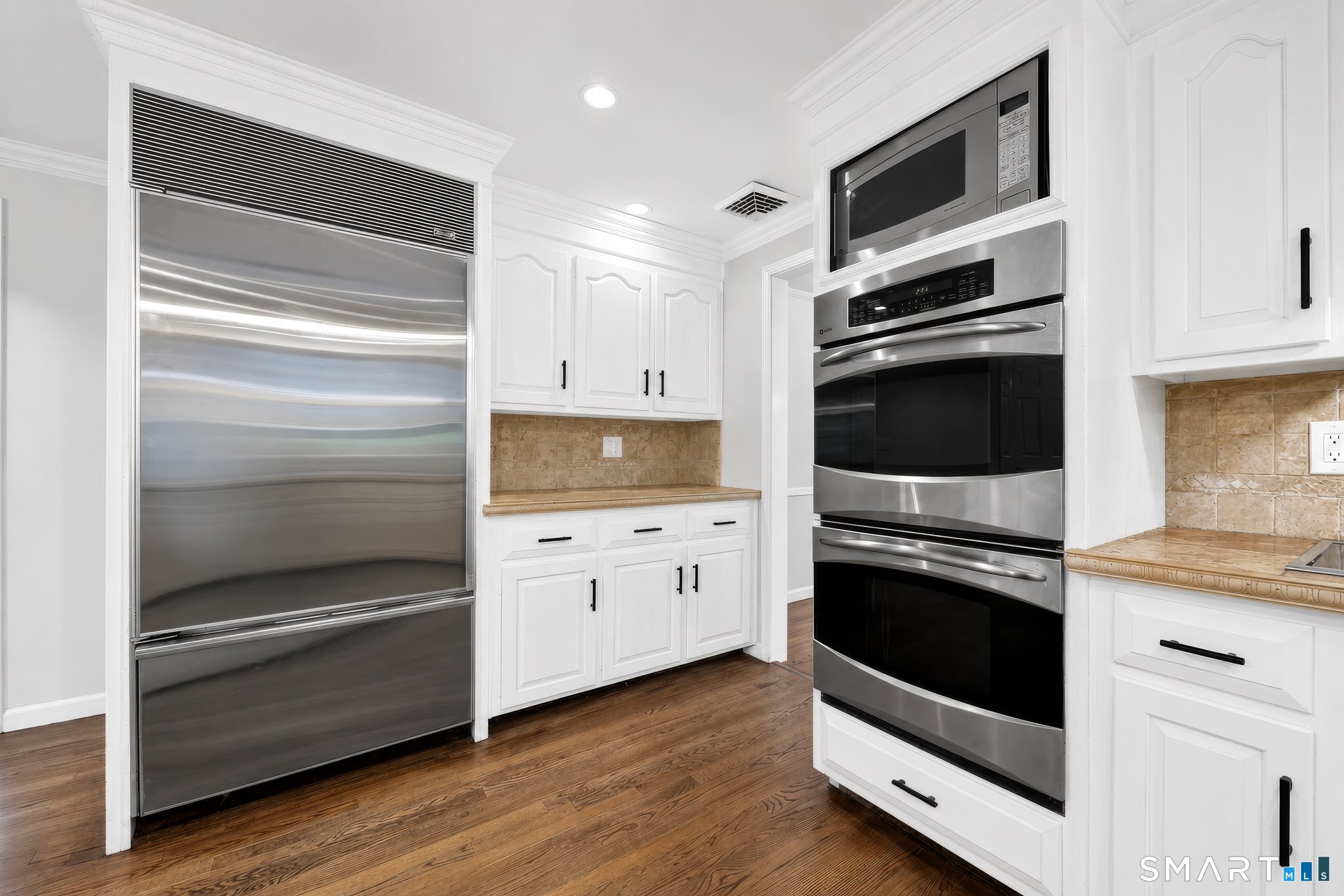 70 Barrack Hill Road Ridgefield, CT 06877 - Photo 5 of 32 a kitchen with white cabinets and stainless steel appliances