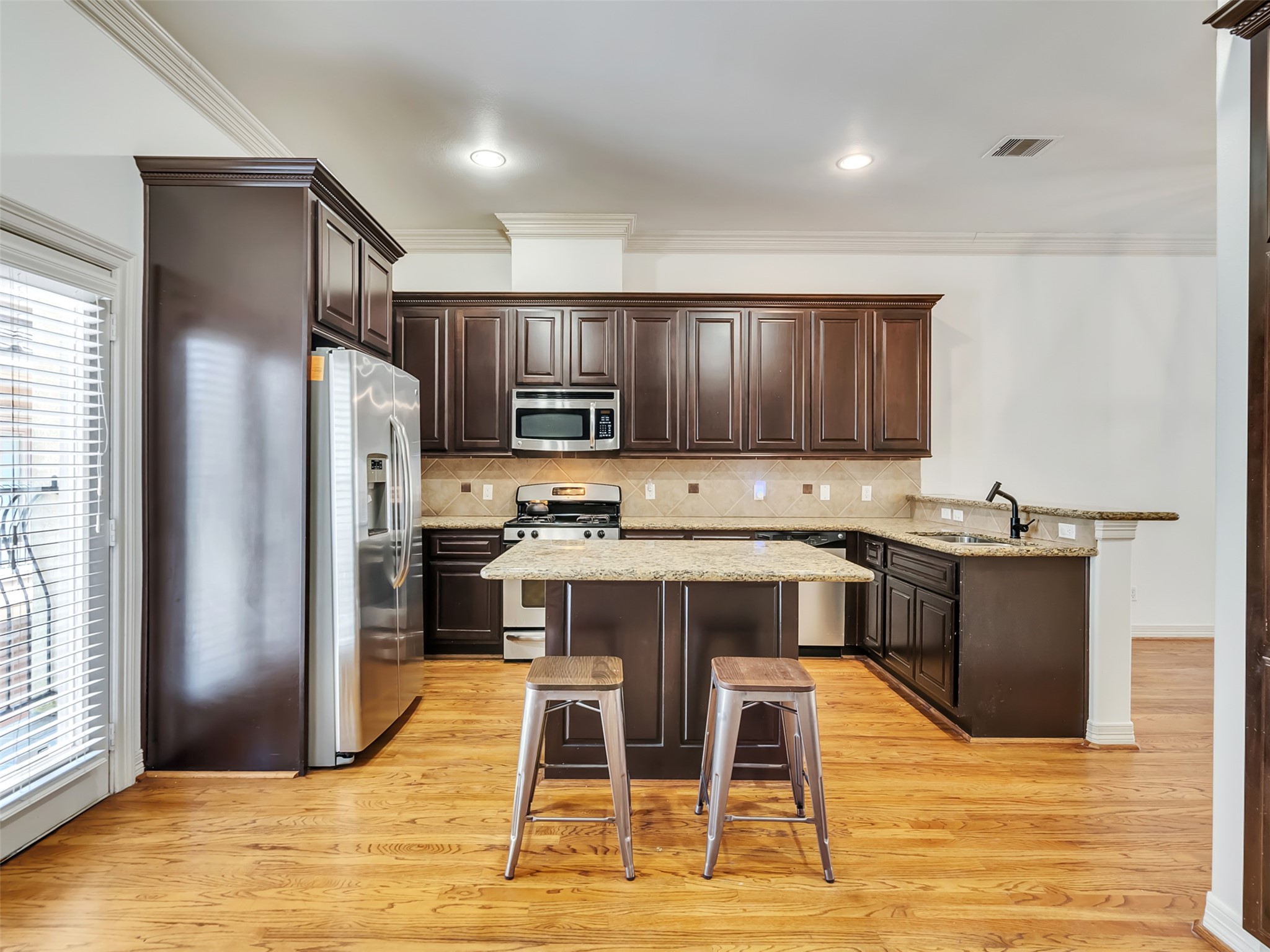 2540 Prospect Street, Unit B Houston, TX 77004 - Photo 8 of 37 a kitchen with stainless steel appliances granite countertop a refrigerator stove microwave and sink