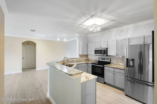a kitchen with a refrigerator sink and microwave