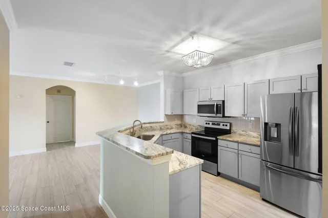 a kitchen with a refrigerator sink and microwave