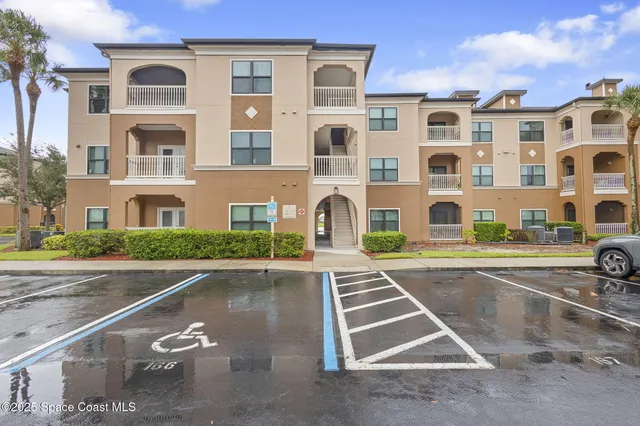 a front view of a residential apartment building with a yard