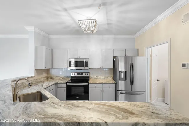 a view of kitchen with microwave and cabinets