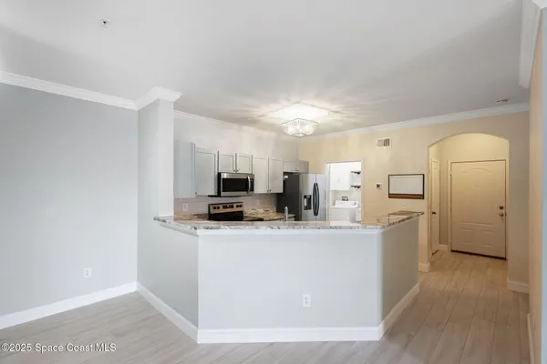 a view of kitchen with microwave and cabinets