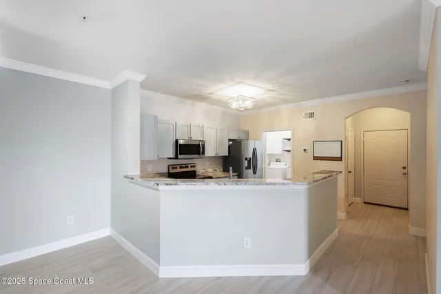 a view of kitchen with microwave and cabinets