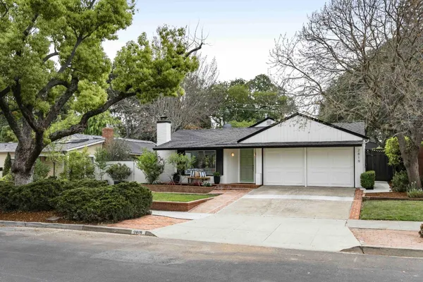 a front view of a house with a garden
