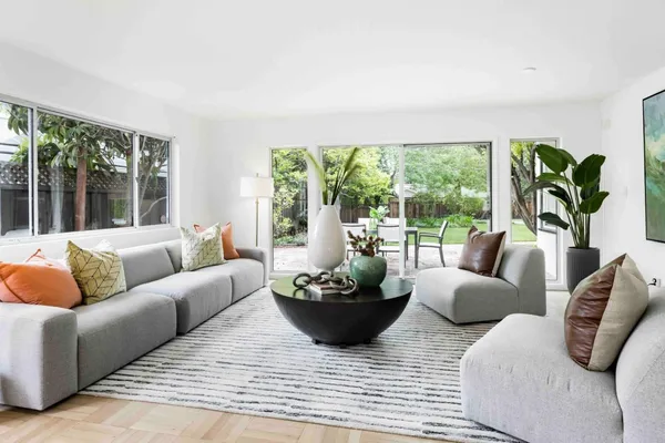 a living room with furniture and a potted plant