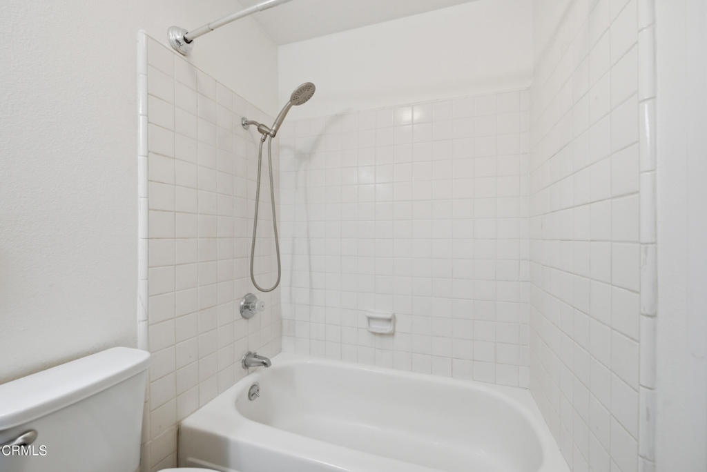 1210 Carlsbad Place Ventura, CA 93003 - Photo 14 of 22 a white bath tub sitting next to a white toilet and a shower