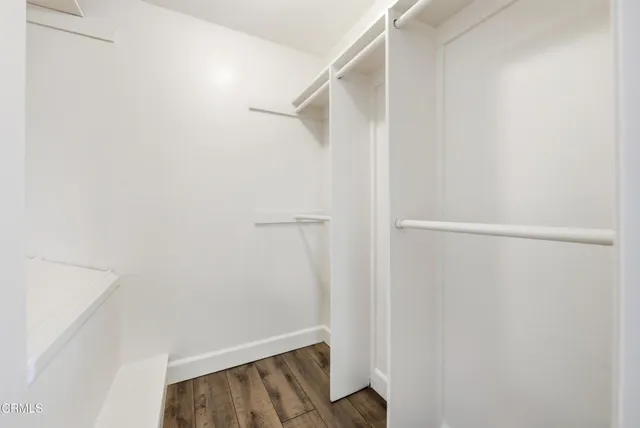a view of walk in closet with empty racks