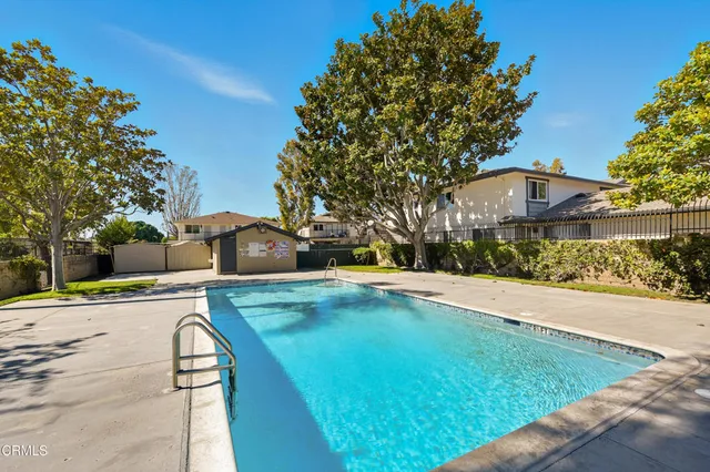 a view of a white house with a yard