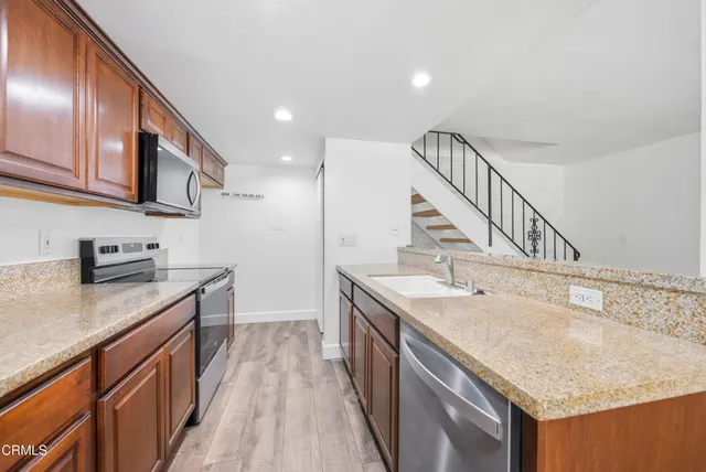 a kitchen with a sink stove and cabinets