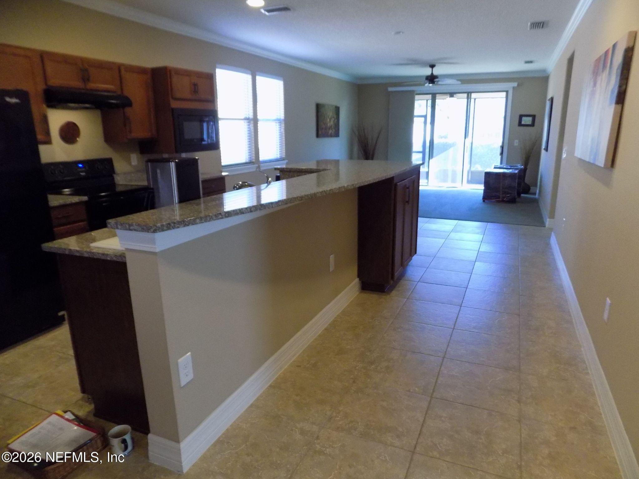 144 Goldenrod Park Road Ponte Vedra, FL 32081 - Photo 14 of 40 a large kitchen with a counter space a sink a window and stainless steel appliances