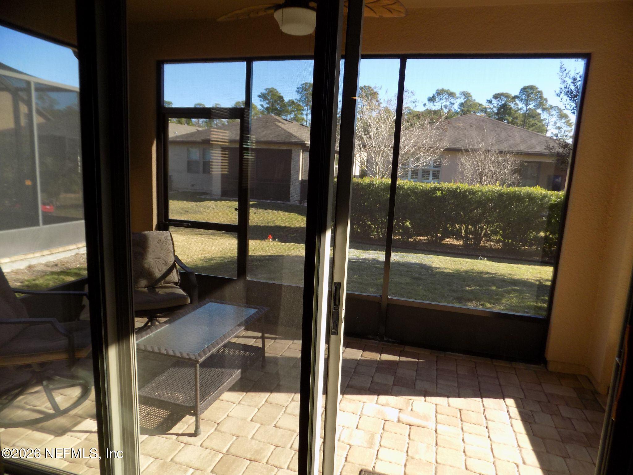 144 Goldenrod Park Road Ponte Vedra, FL 32081 - Photo 18 of 40 a view of a glass door and an outdoor from dining room