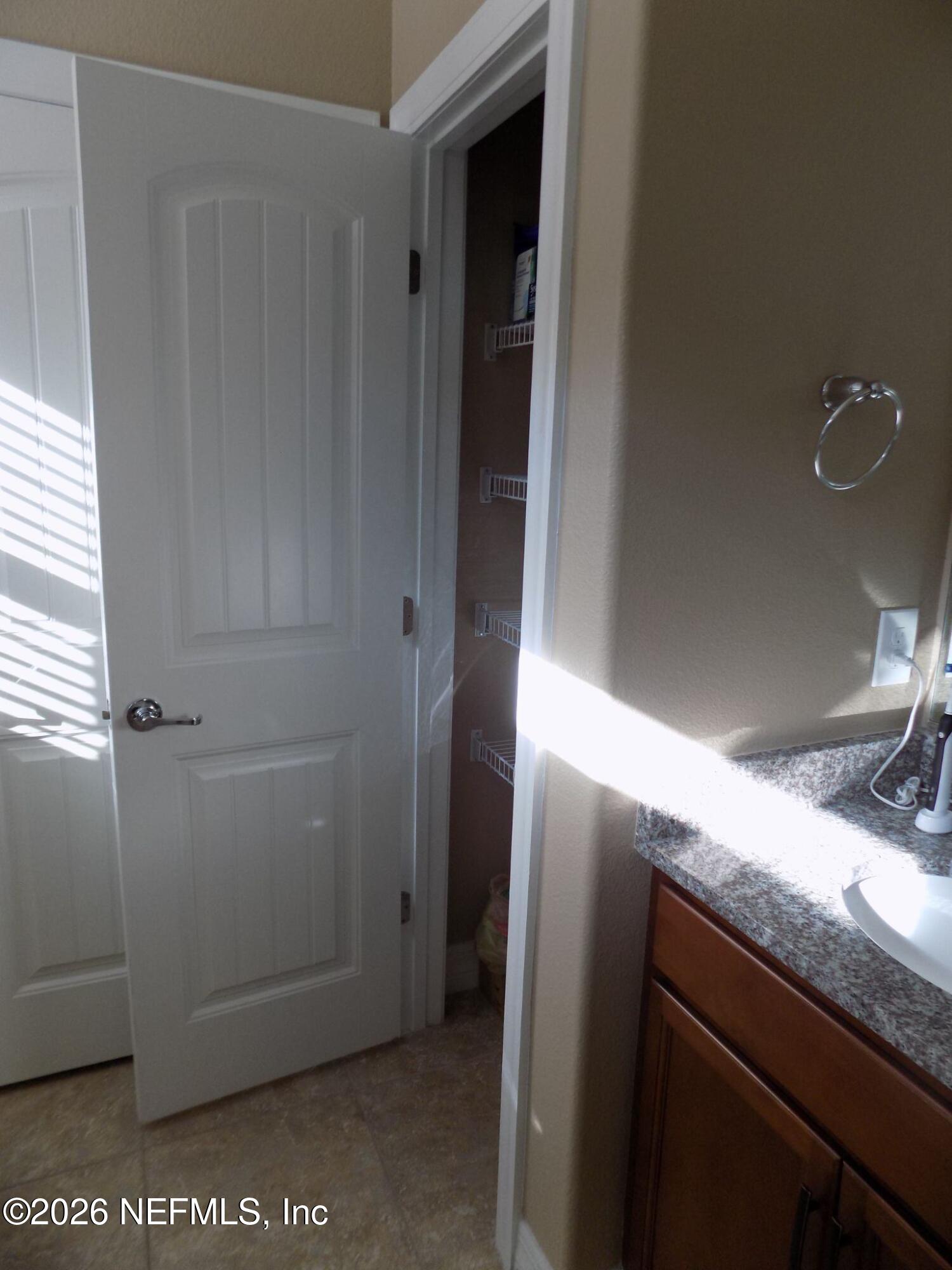 144 Goldenrod Park Road Ponte Vedra, FL 32081 - Photo 23 of 40 a bathroom with a granite countertop sink and a mirror