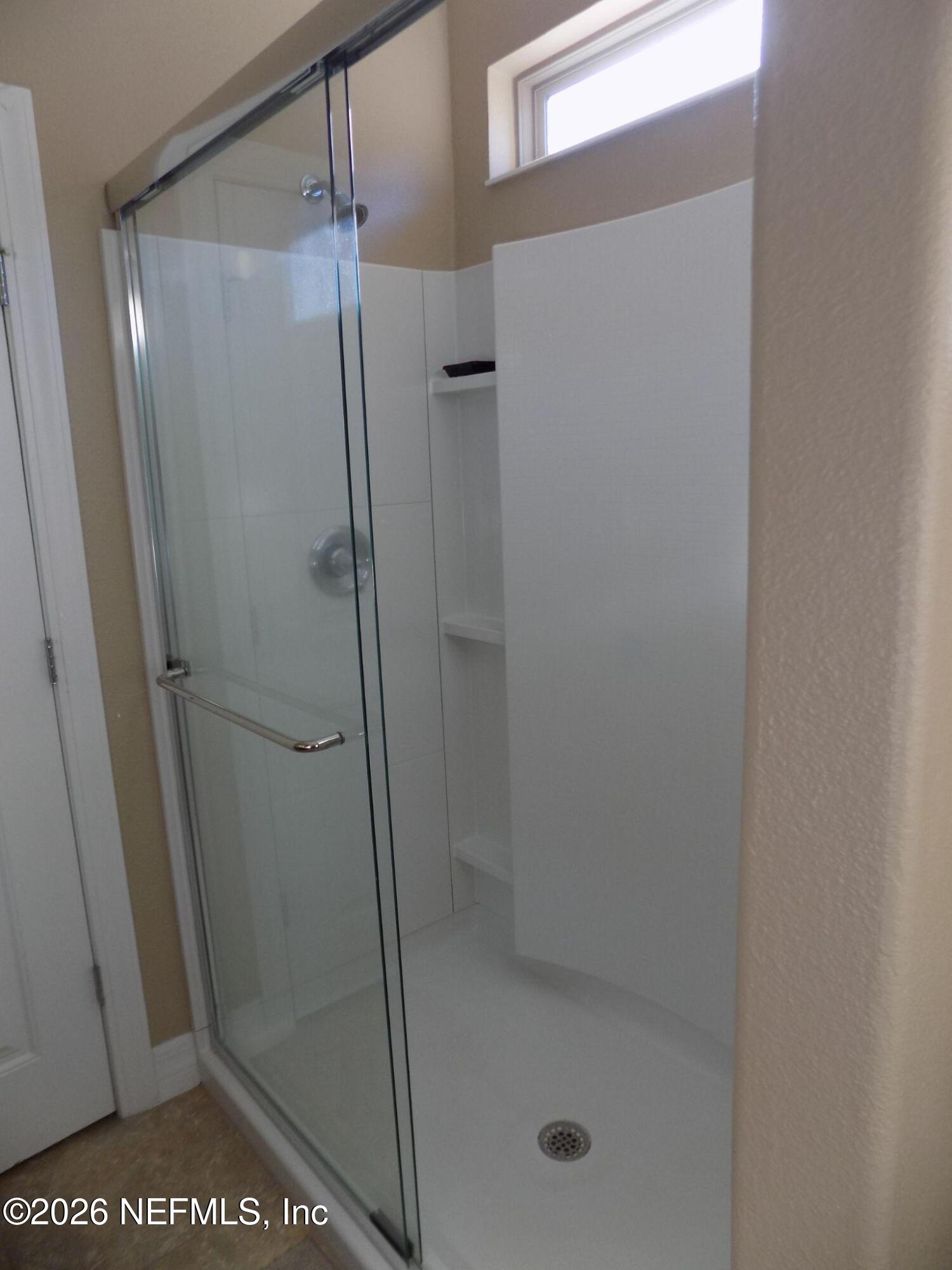 144 Goldenrod Park Road Ponte Vedra, FL 32081 - Photo 24 of 40 a bathroom with a glass shower door