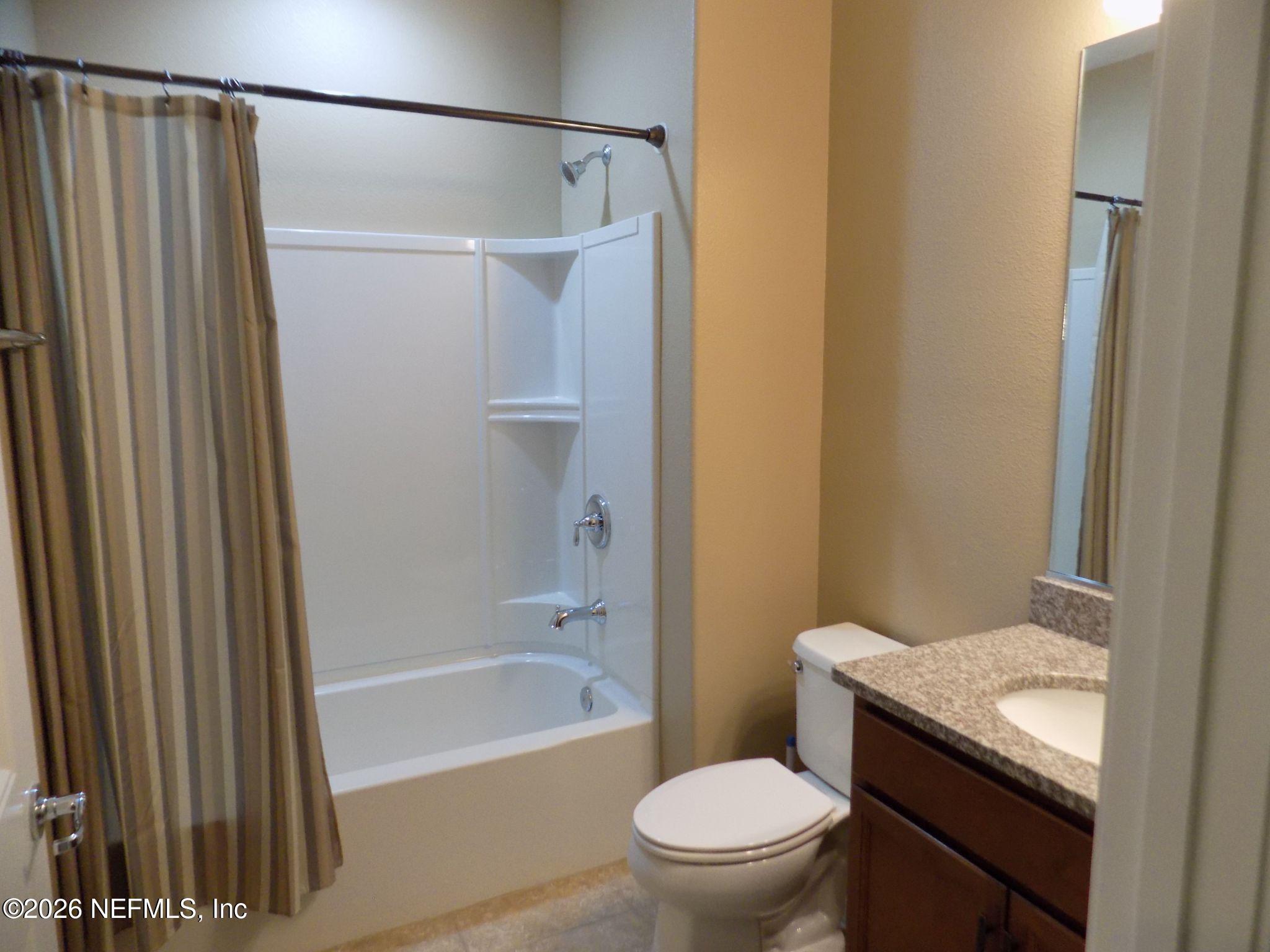 144 Goldenrod Park Road Ponte Vedra, FL 32081 - Photo 26 of 40 a bathroom with a granite countertop bathtub shower sink vanity and toilet