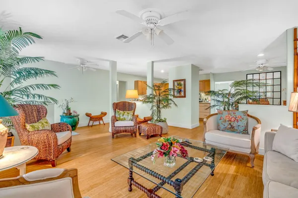 a living room with patio furniture and a fireplace