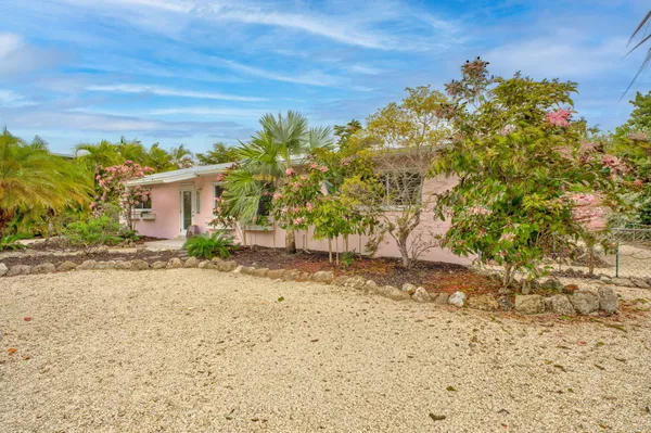 a kitchen with stainless steel appliances kitchen island granite countertop a sink a counter space and a window
