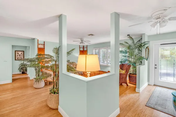 a kitchen with a refrigerator a stove a dining table and chairs