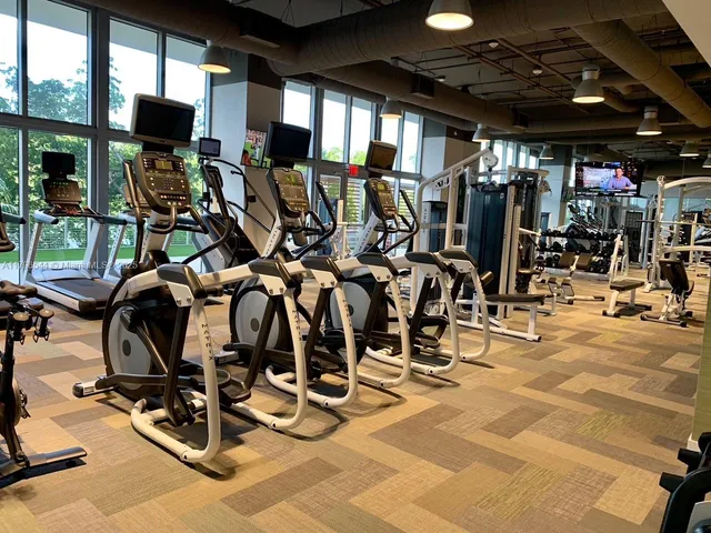 a living room with furniture and a book shelf