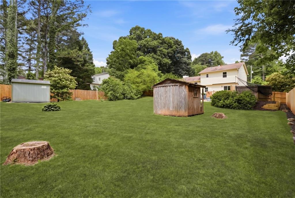 338 Arbour Way Suwanee, GA 30024 - Photo 26 of 32 a backyard of a house with table and chairs