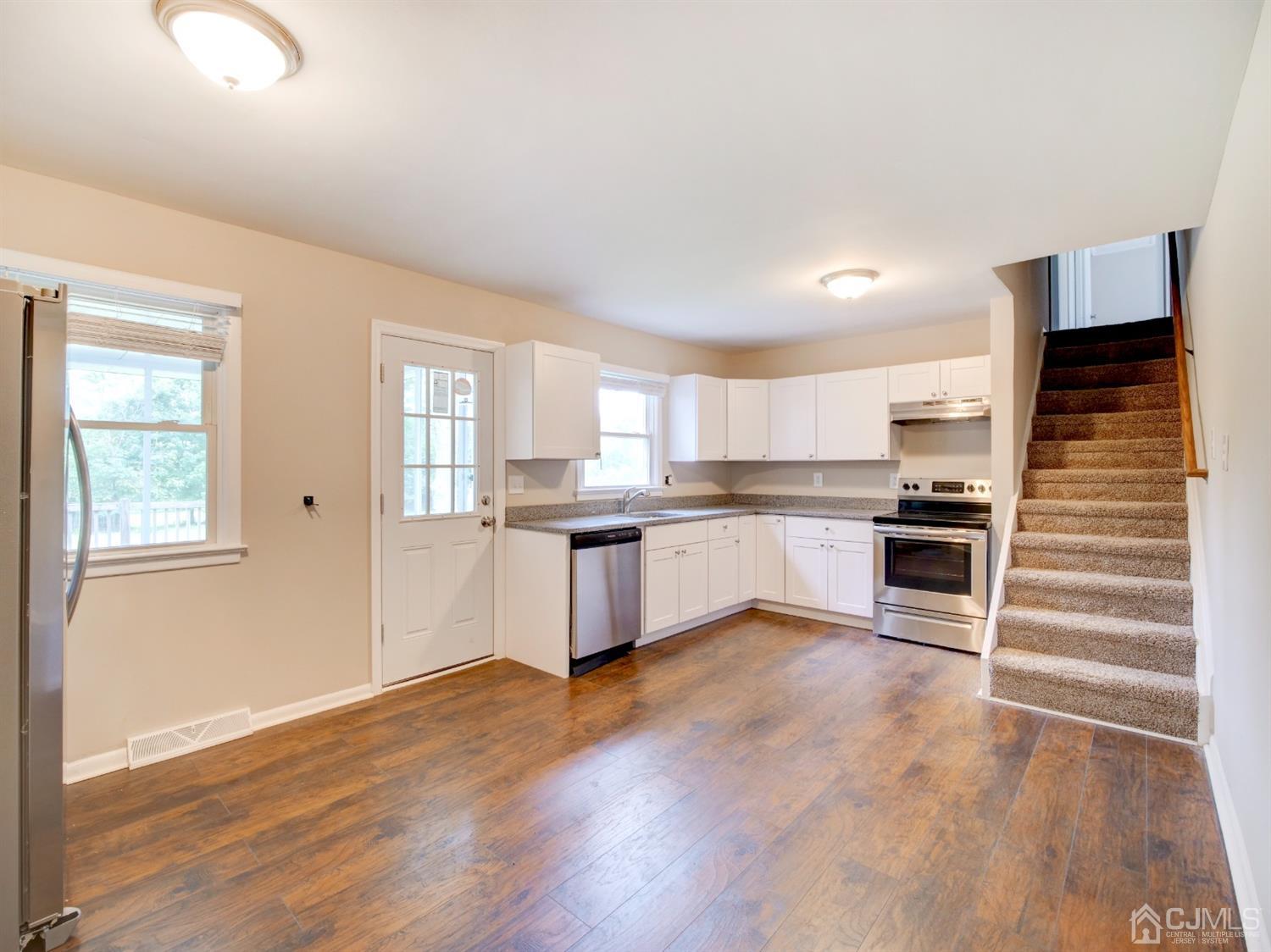 80 Pleasant Valley Road Old Bridge, NJ 08857 - Photo 3 of 15 a large kitchen with cabinets and wooden floor